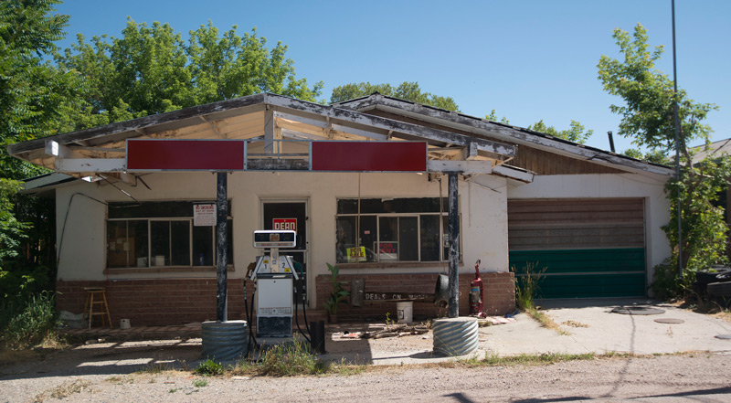 One sign on an abandoned building wants you to imagine its possibilities; another warns you off.