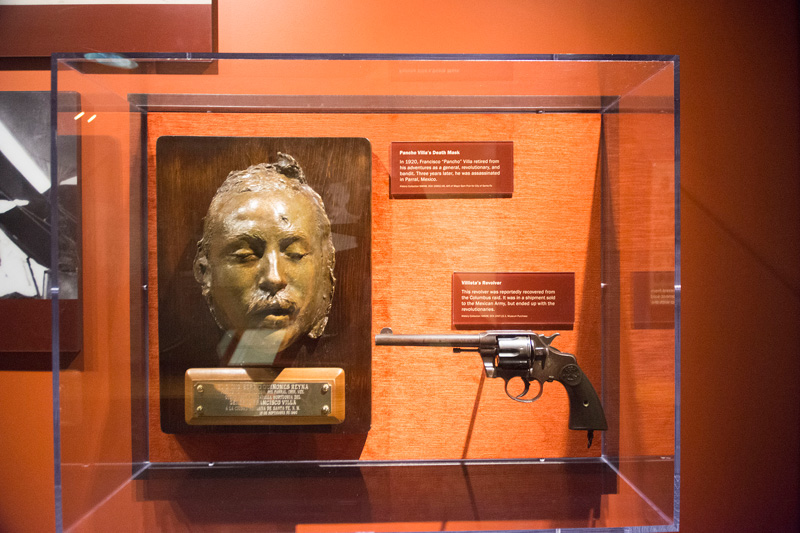 Pancho Villa's death mask, in a museum case with his pistol.