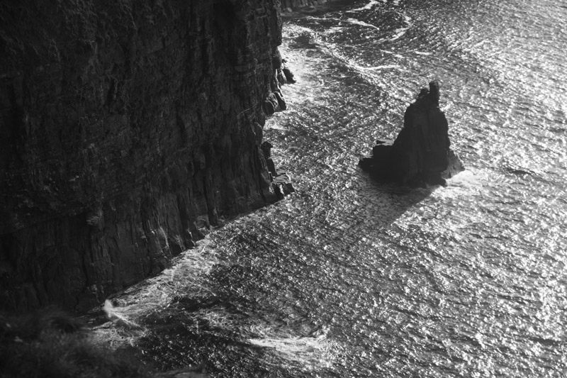 A portion of the Cliffs of Moher, in silhouette.