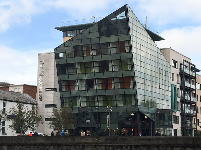 A modern hotel with glass sides, shaped like a ship's prow.