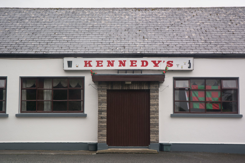 A simple pub with a white front.