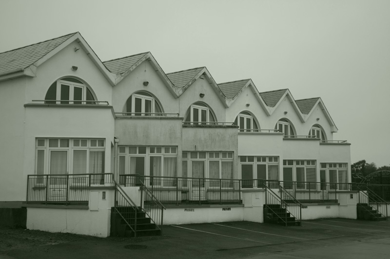 A row of two-story, angular apartments.