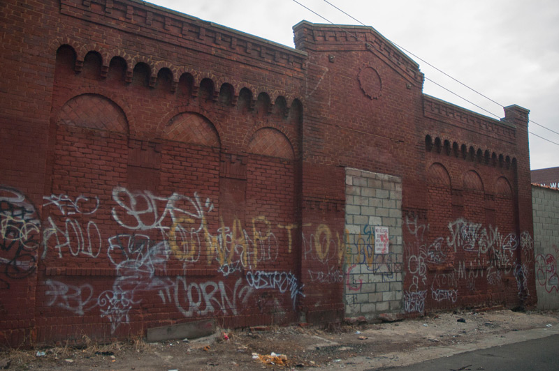 A long-abandoned garage, covered in graffiti tags.