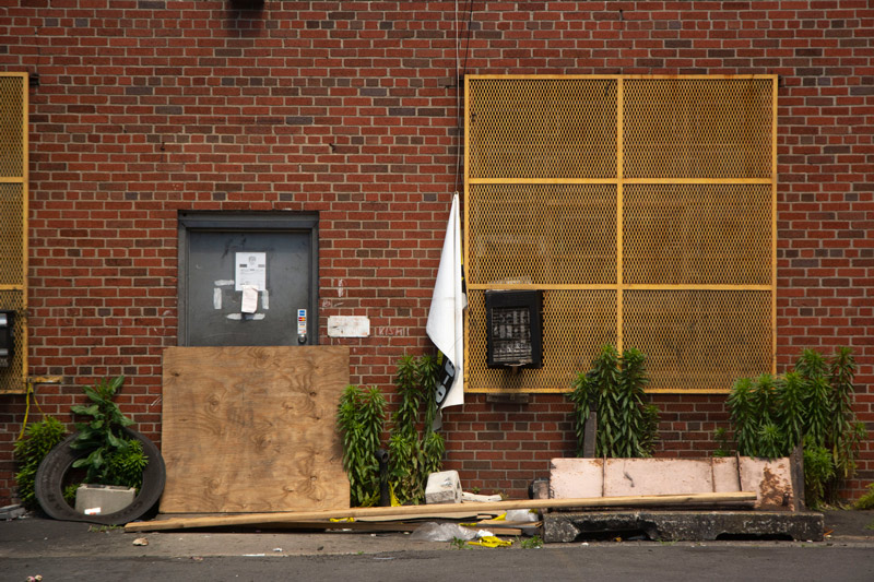 The photo a metal screen protecting a window, with a white towel hanging off a corner.