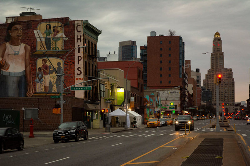 The photo shows the Williamsburgh Bank Building and a mostly empty avenue.