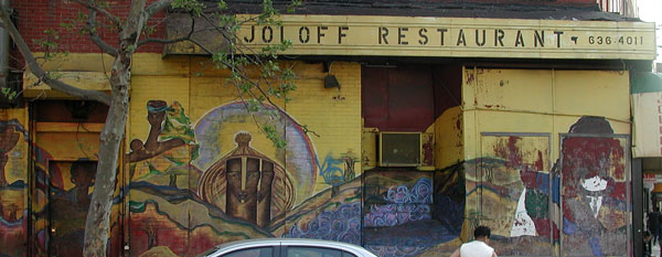 A restaurant with an
African-influenced mural outside.