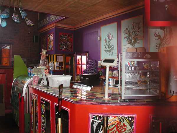 A concession stand, in bright colors of purple and
red, with floral prints.