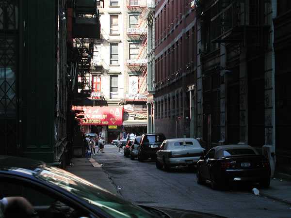 Sunlight shines on the buildings at the
end of a darkened alley.