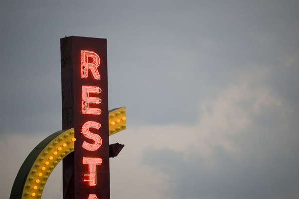 A diner's neon sign lights up the sky