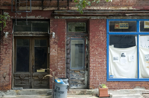 Sets of doors and windows on an old, brick building