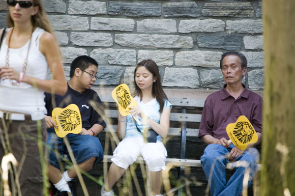 Tourists on a bench on a hot day