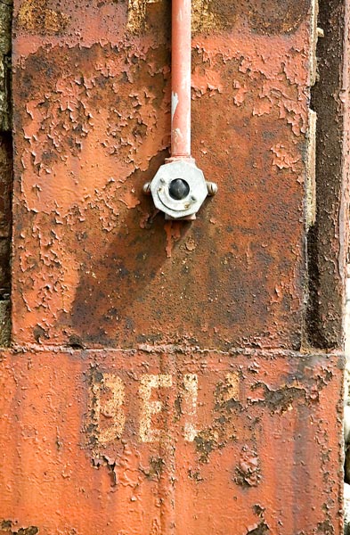 The button for a bell, on a rusted girder