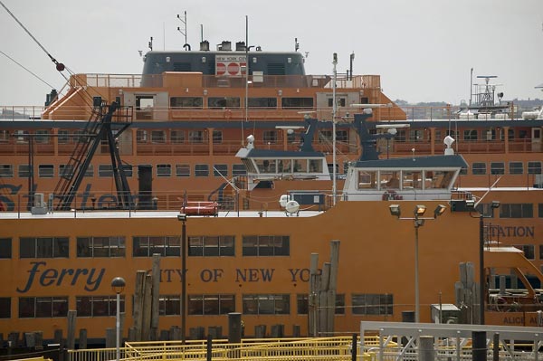 Orange ferries are clustered in their slips