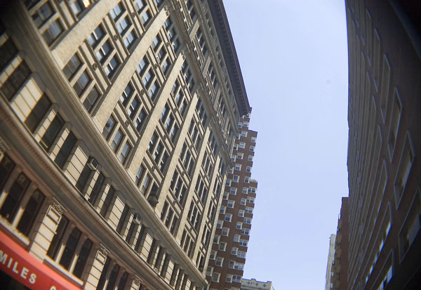 Buildings, shot from the ground, converge on the
sky.