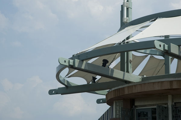 A canopy hangs on the radii on top of a roof.