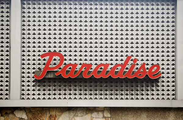 A catering hall's sign calls out 'Paradise.'