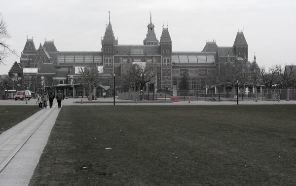 An approach to Amsterdam's famous museum, over a lawn.