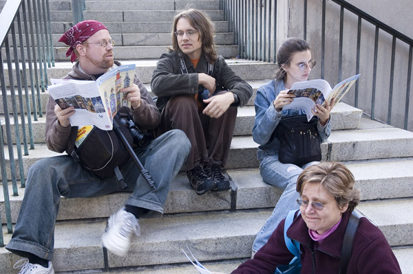 Four people taking a break on a set of stairs.