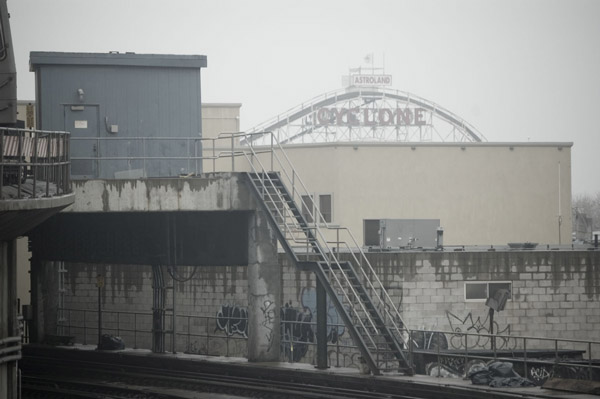 Fog obscures buildings in the distance.