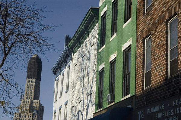 Four brick buildings, painted different colors.