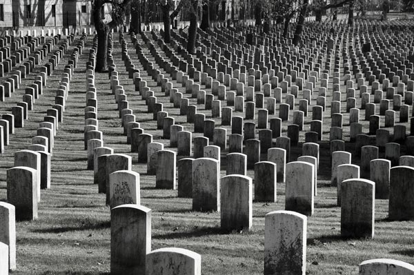 Rows of uniform, white, military headstones.