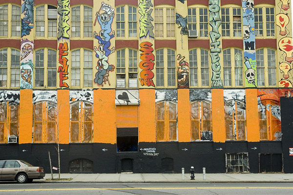 A building has been taken over by graffiti, with permission.
