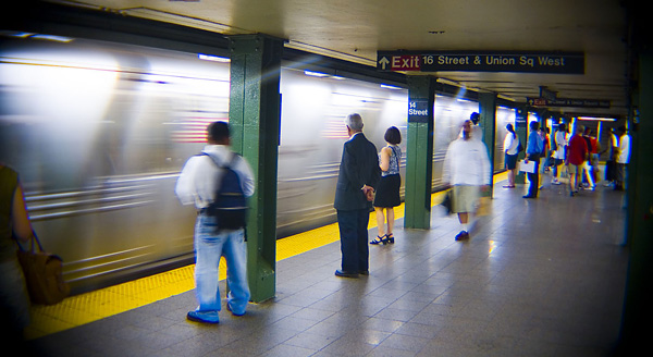 New Yorkers wait for an arriving train to slow down
and stop.