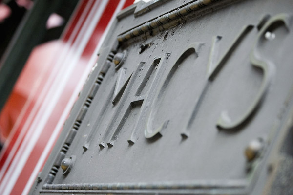 A grey metal plaque with the name 'Macy's' in raised
letters.