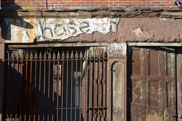 Plaster is falling off the facade, and rust is
apparent.