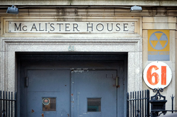 An old entrance, with metal double doors and a fallout
shelter sign.