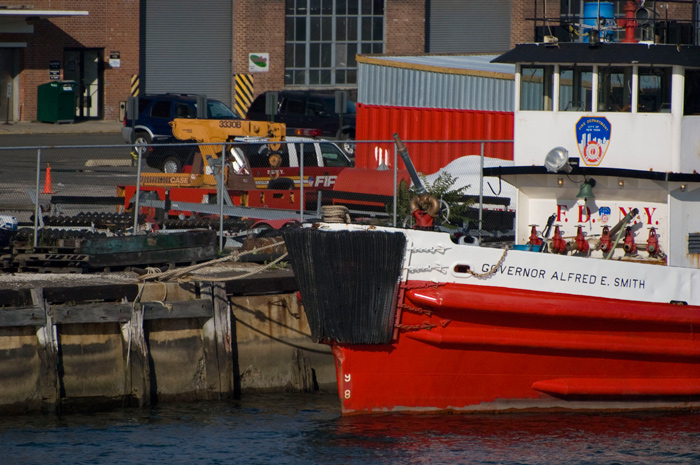 A brightly painted fire boat, named after Governor Alfred E Smith, sits docked.