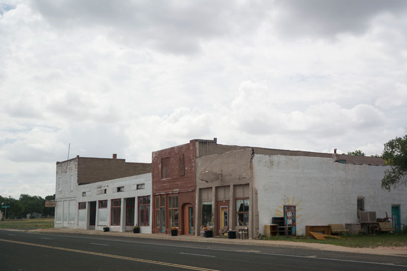 A strip of old buildings in a small town where no one seems about.
