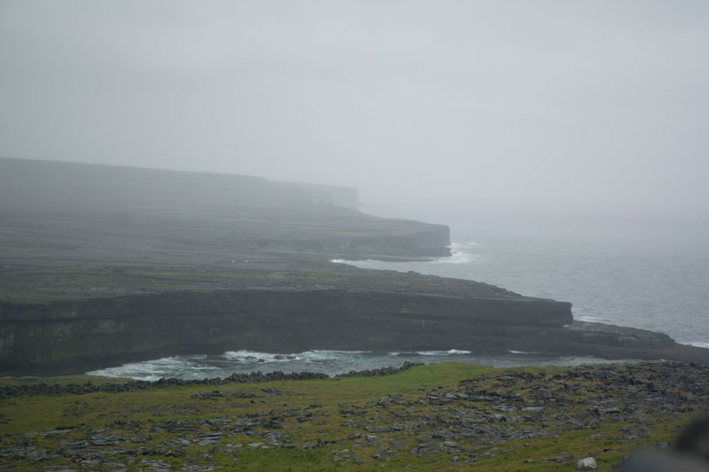 Jagged cliffs on an Irish coast, wrapped in fog.