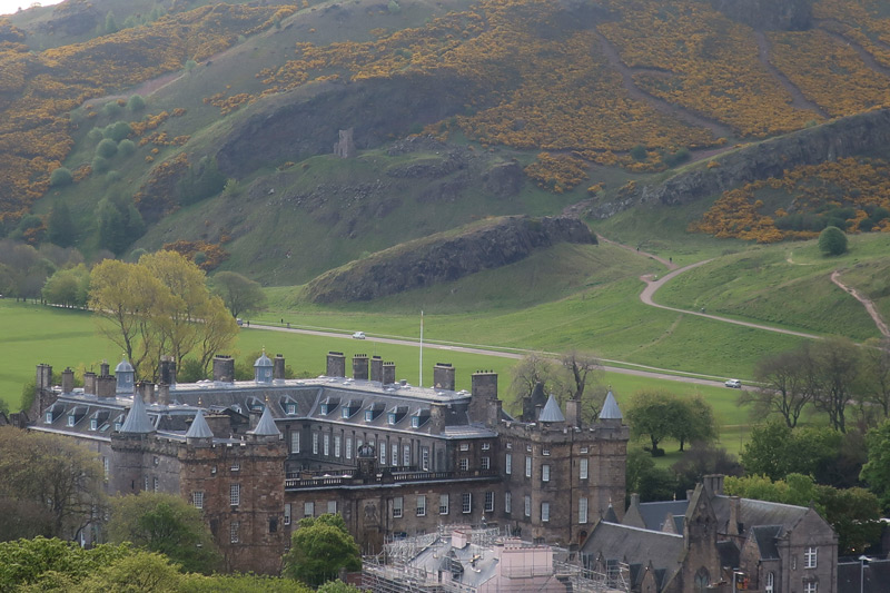 The photo shows Holyrood Palace, from nearby Calton Hill.