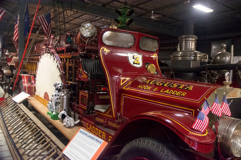 The photo shows an old fire engine, complete with ladders and life net.