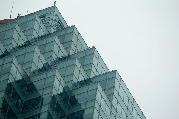The top of an office tower, with many glass corners.